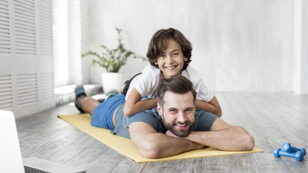 Father's Day Gifts That Actually Matter (2025 Guide) 9 Kid and his father doing sport at home
