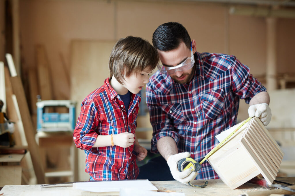 Father's Day Gifts That Actually Matter (2025 Guide) 10 Man and little boy measuring height of starling-house